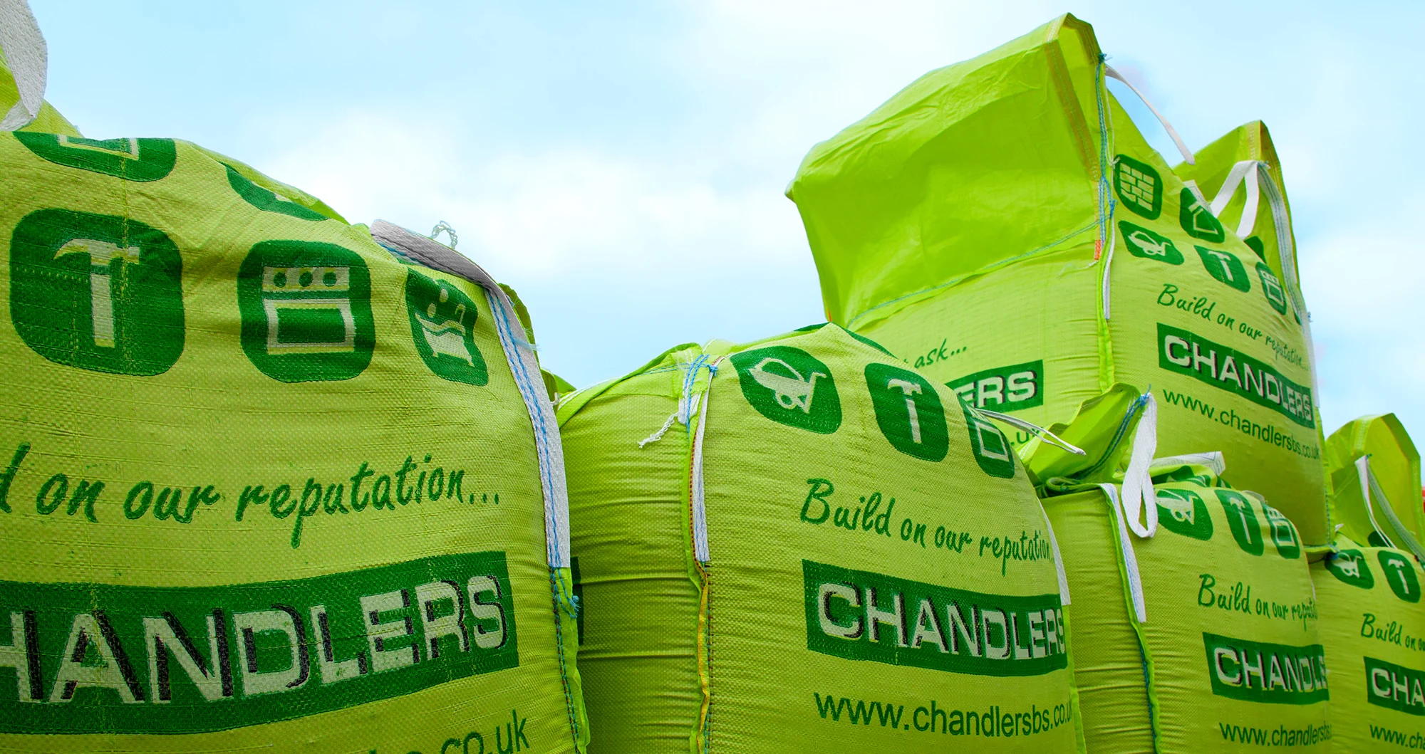 Green Chandlers Builders Merchants bulk and tonne bags stacked.