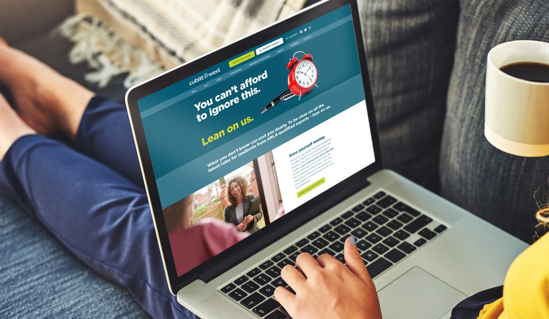 Person using Arun Estates' website on a laptop to showcase responsive design.