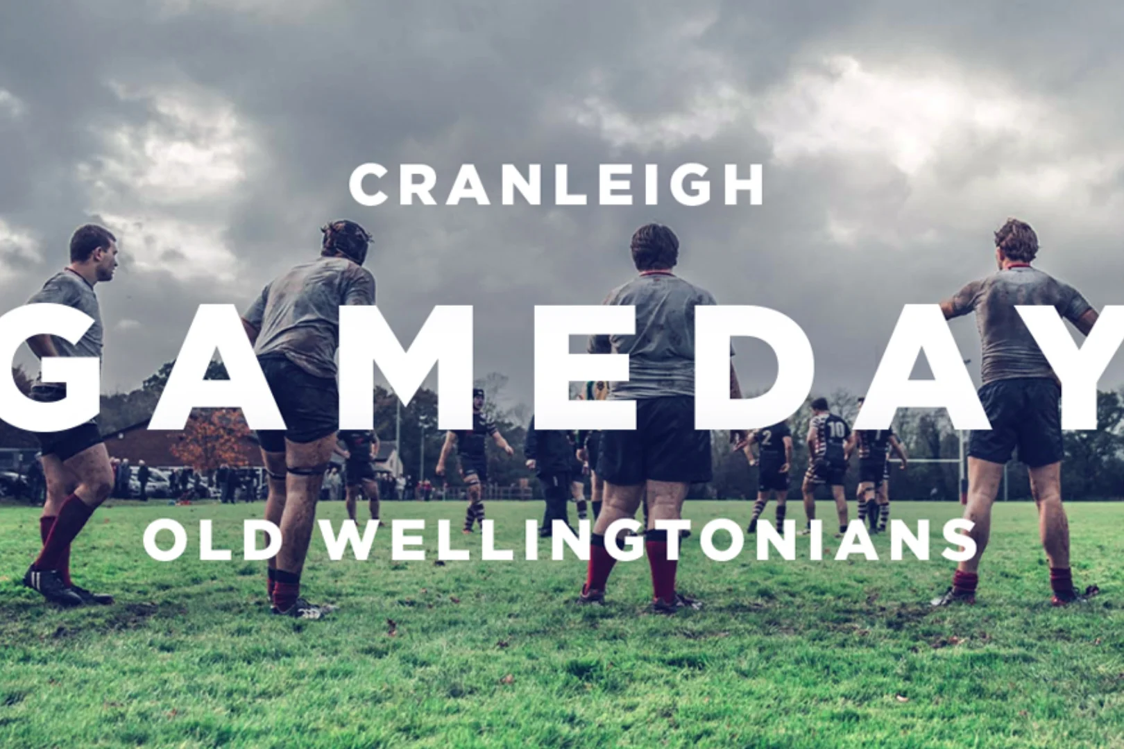 Rugby match being played on a dramatic grey day with the words in whit and all caps 'Cranleigh gameday old wellingtonians'