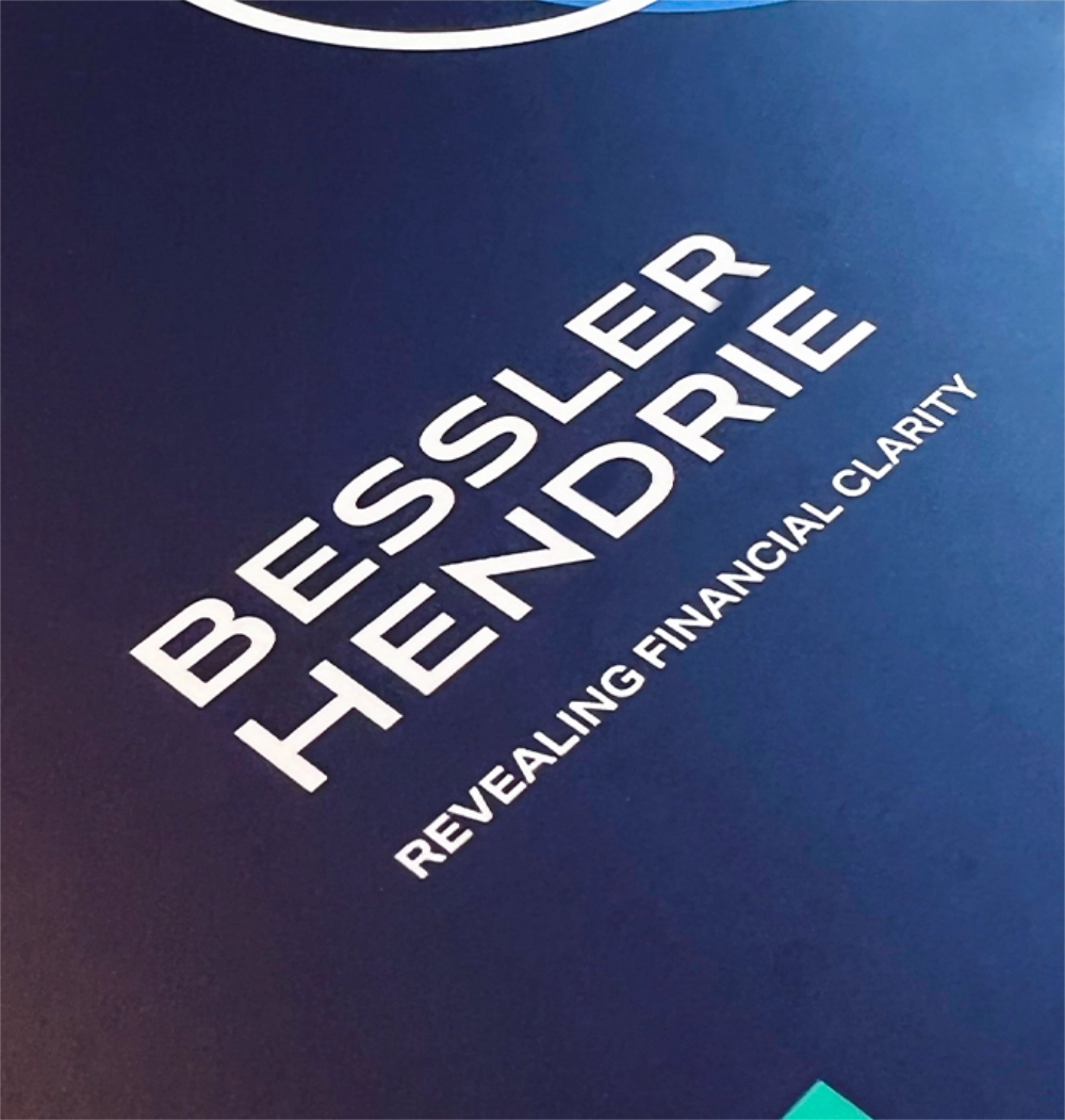 Bessler Hendrie logo on a blue screen tilted at an angle.