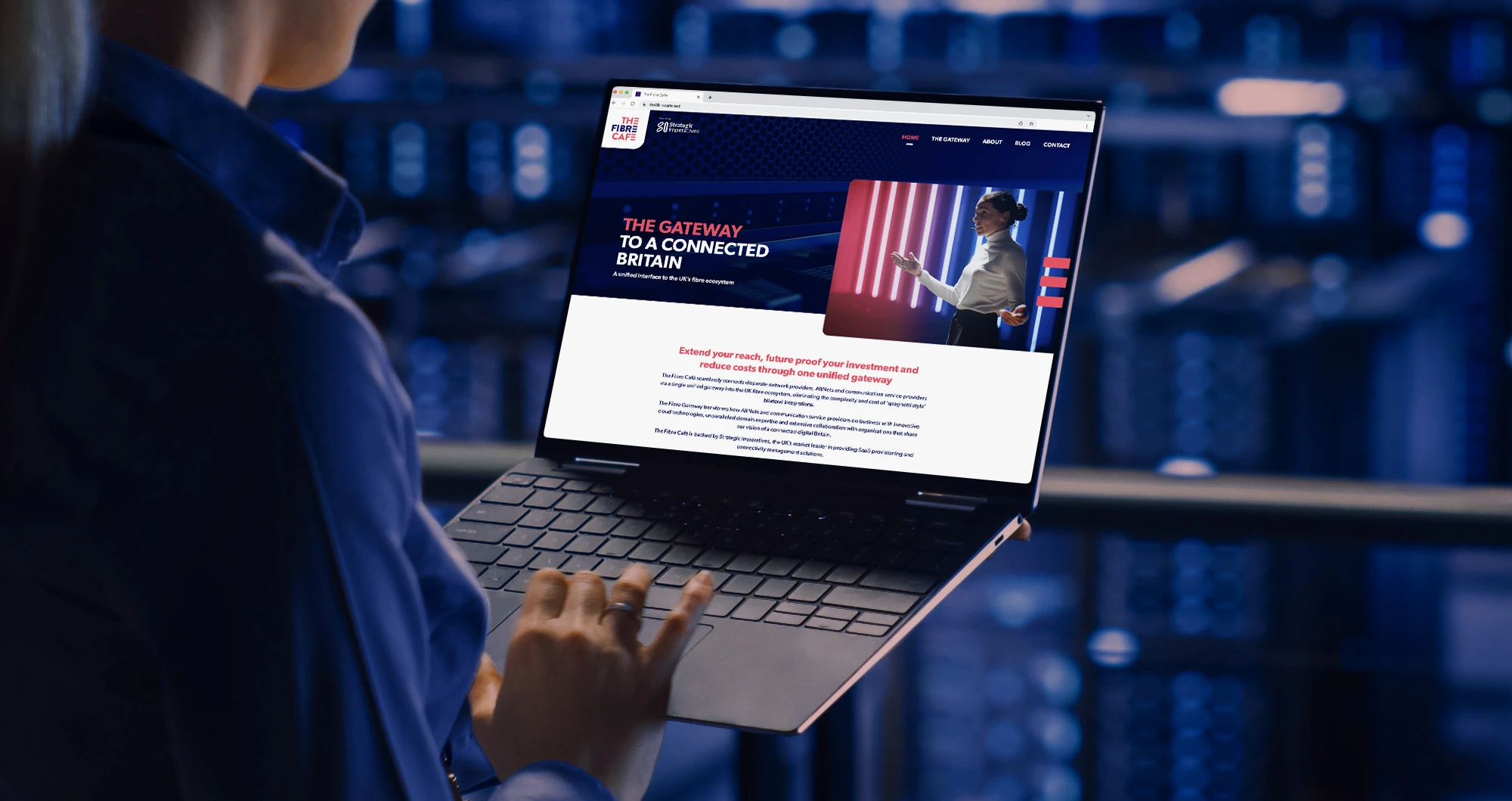 Person on a city balcony using their laptop with The Fibre Cafe's website running on it.