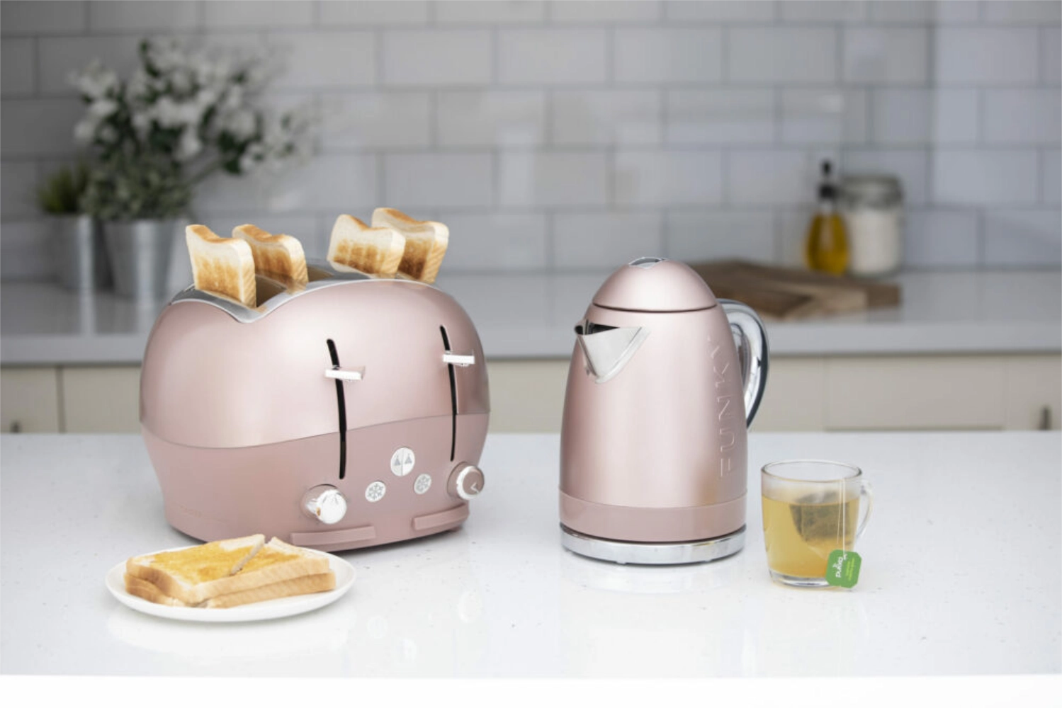 The Funky Appliance Company's toaster and kettle on a kitchen counter in blush pink.