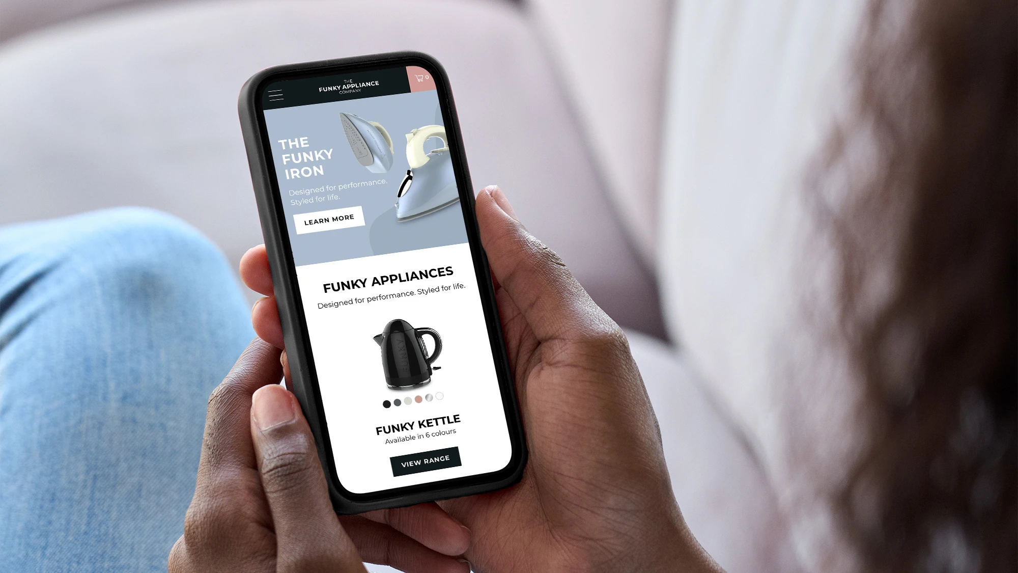 Person using The Funky Appliance Company's website on a mobile phone.
