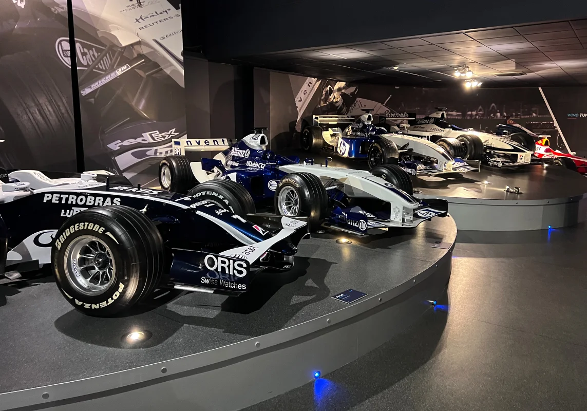 Some F1 race cars on display at a show.