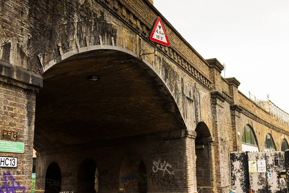 Archway under a bridge with graffiti 