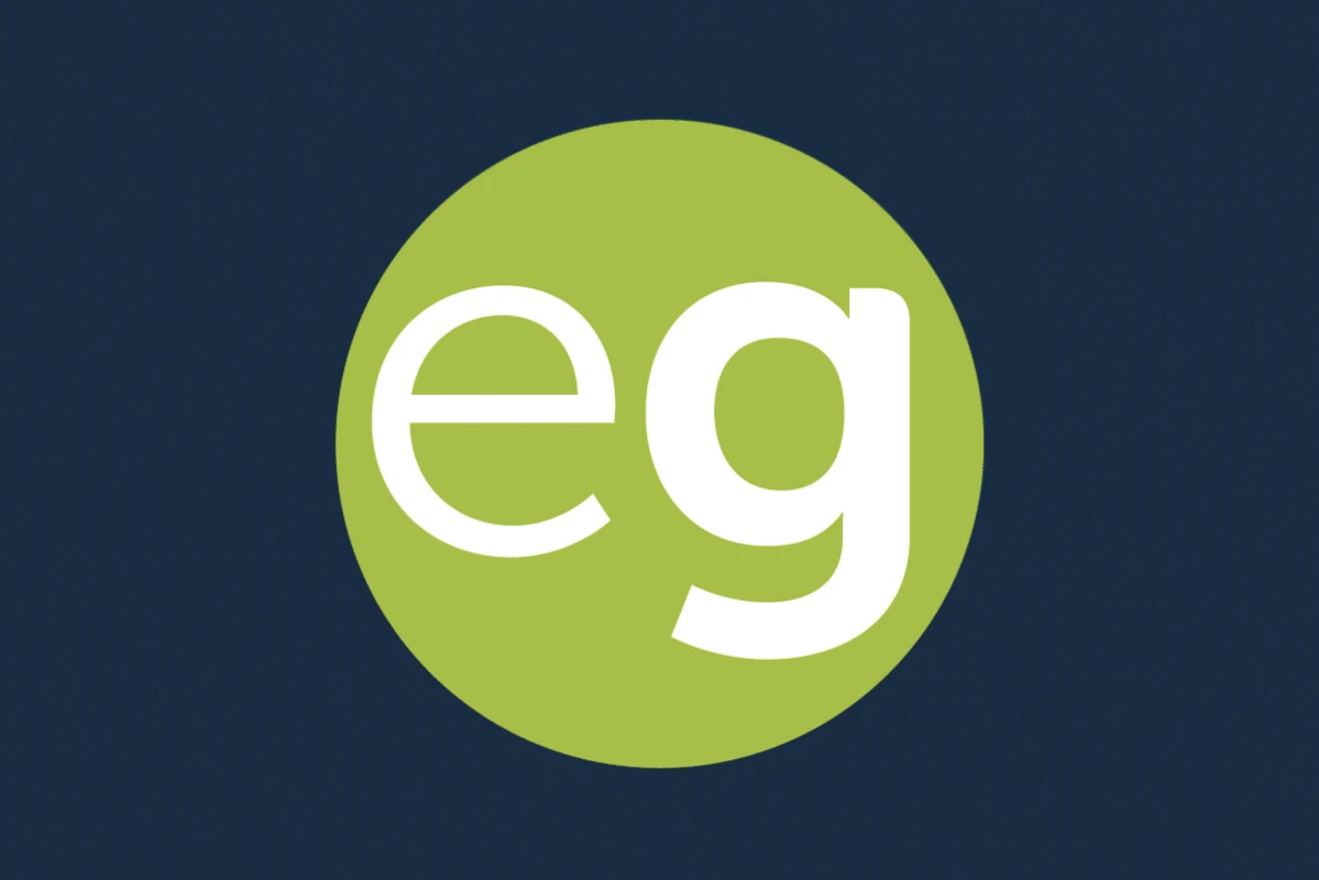 White lowercase letters 'eg' inside a green circle on a dark blue background. - The Experience Guildford logo