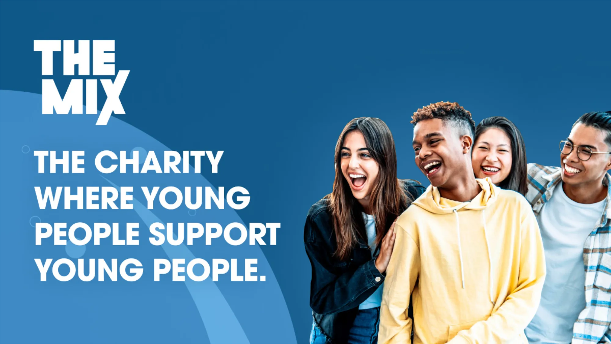 Four diverse young people laughing and standing closely together against a blue background with the text 'THE MIX The charity where young people support young people.'