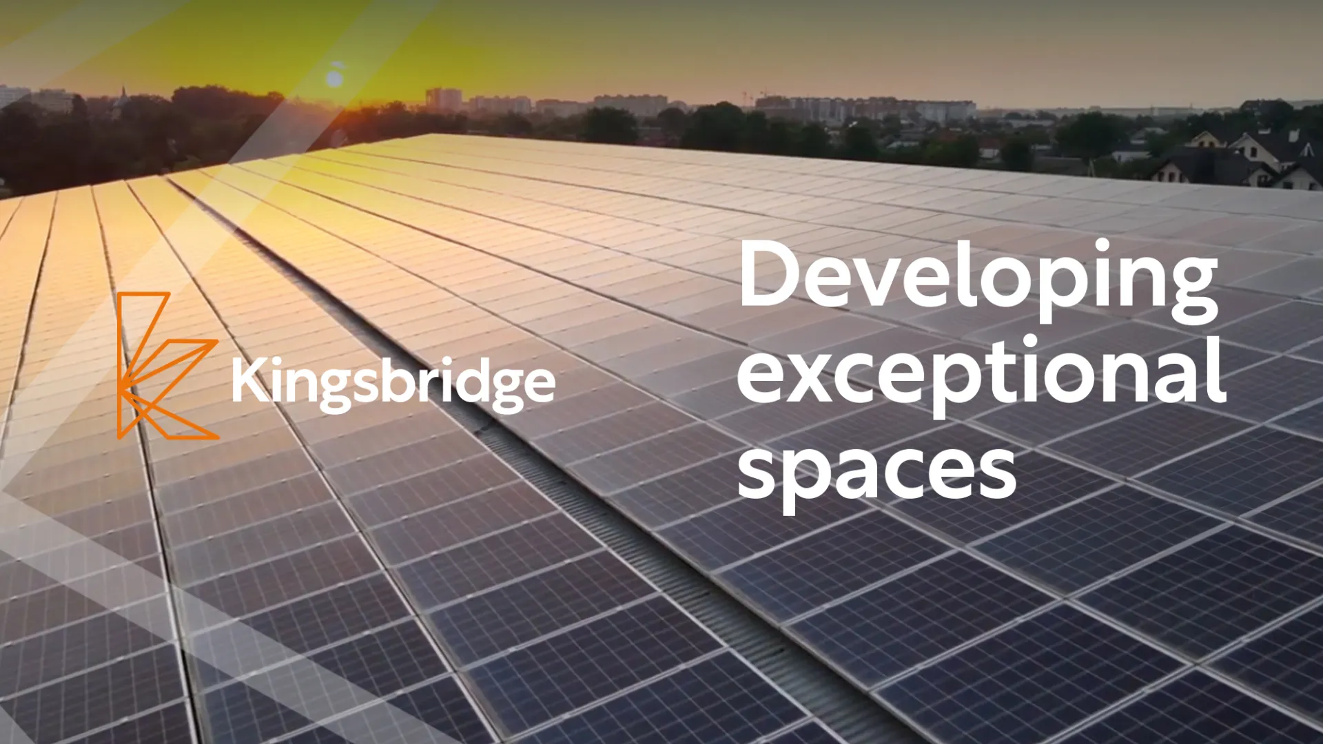 Rooftop covered with solar panels at sunset with Kingsbridge logo and text 'Developing exceptional spaces'.