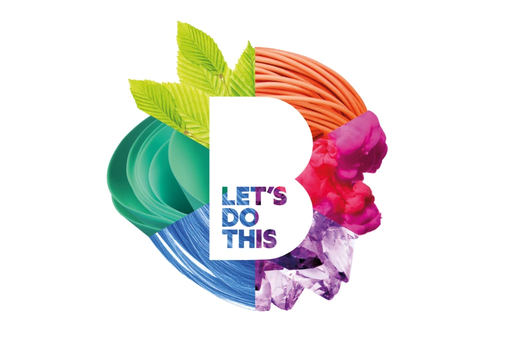 Brooklands Technical College logo filled with colourful textures including green leaves, orange wires, pink smoke, purple crystals, blue paint strokes, and teal petals with the phrase 'LET'S DO THIS' inside.