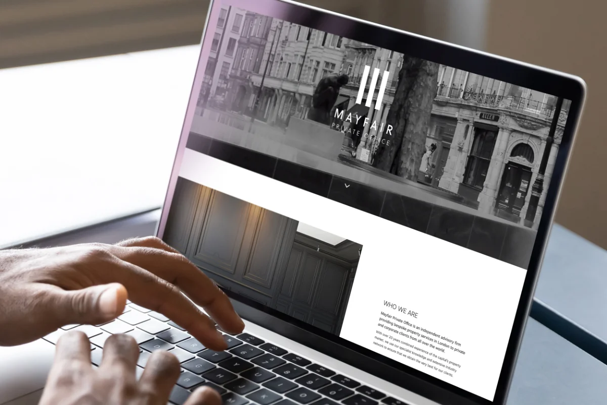 Person using the Mayfair Private Office website on a laptop.