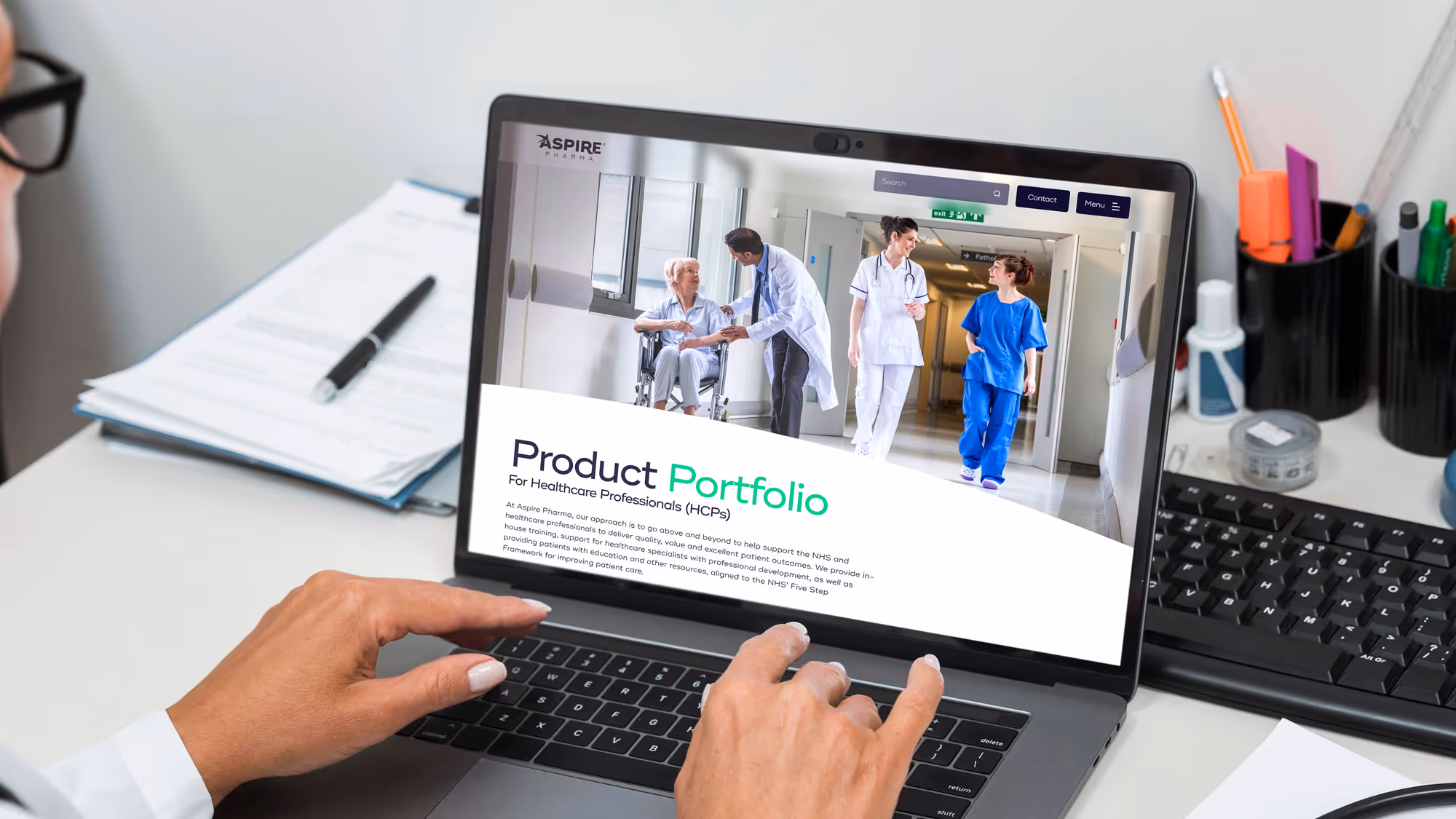 A medical professional using the Aspire Pharma website on a laptop. They are looking at the product portfolio page for healthcare professionals.
