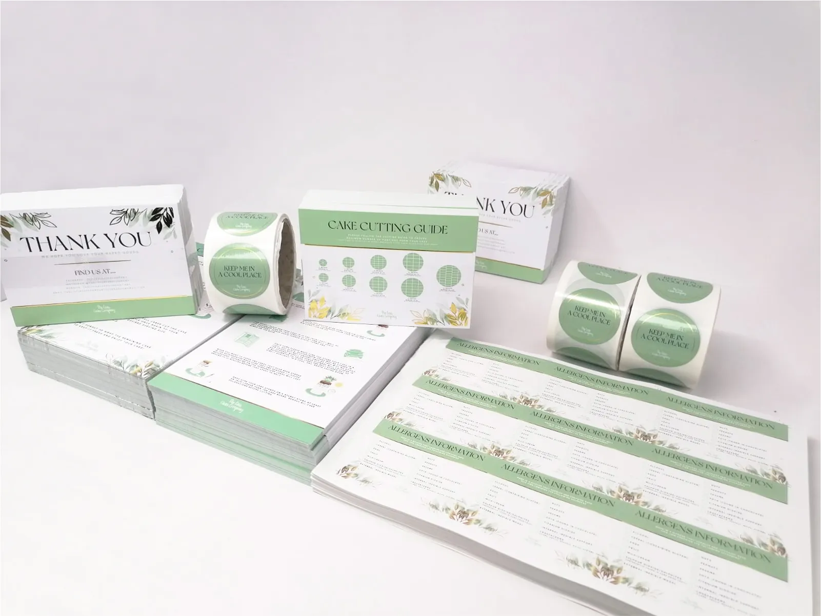 Green and white printed materials including cake cutting guide and stickers