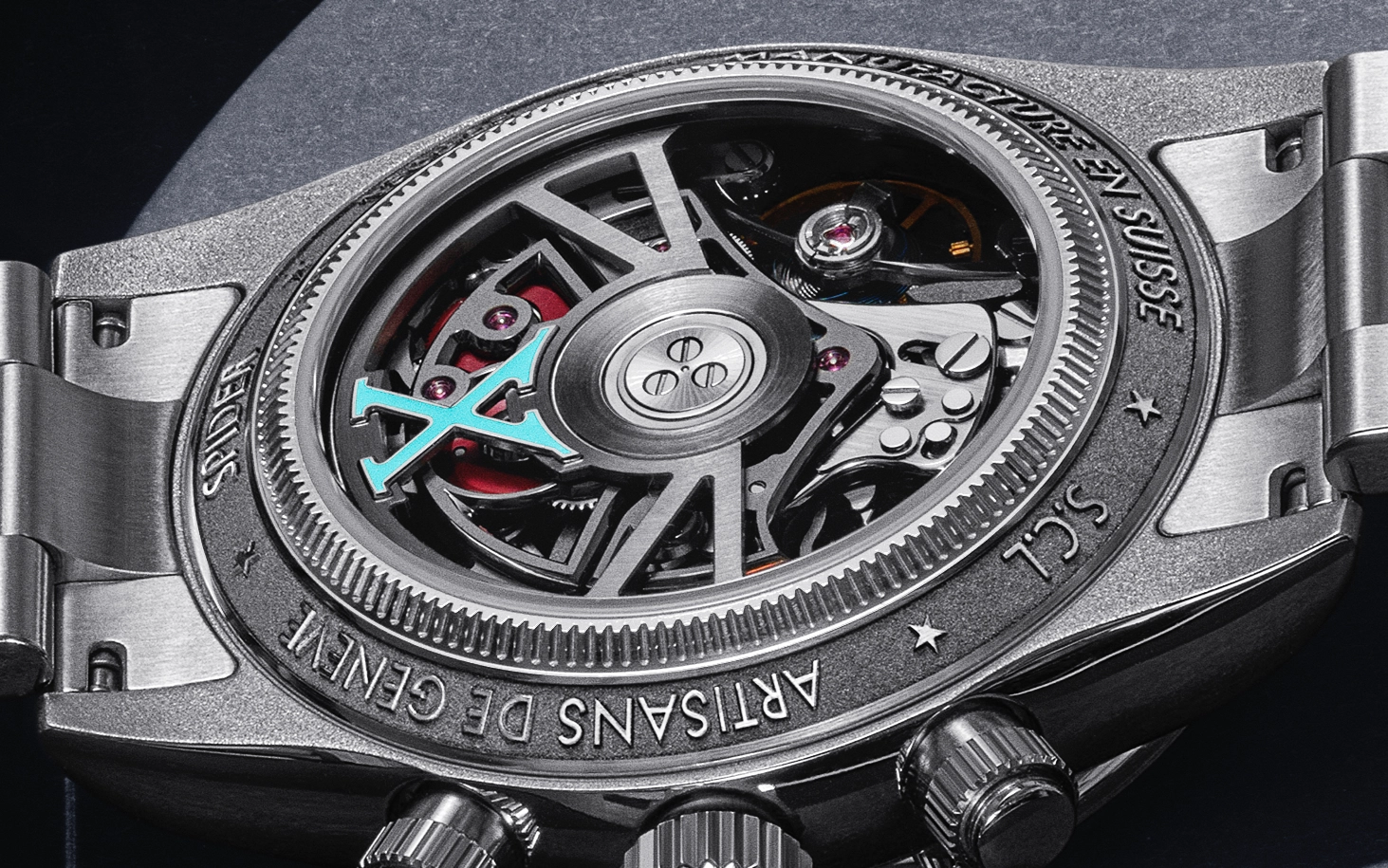 Close-up of the back of a silver mechanical watch with an exposed skeletonized movement and the inscriptions 'Artisans de Genève', 'Spider', 'Made in Suisse', and 'SCL'.