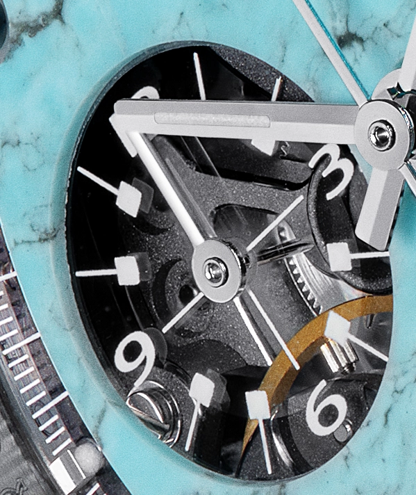 Close-up of a watch face showing mechanical gears and white hour markers 3, 6, and 9 within a turquoise bezel.