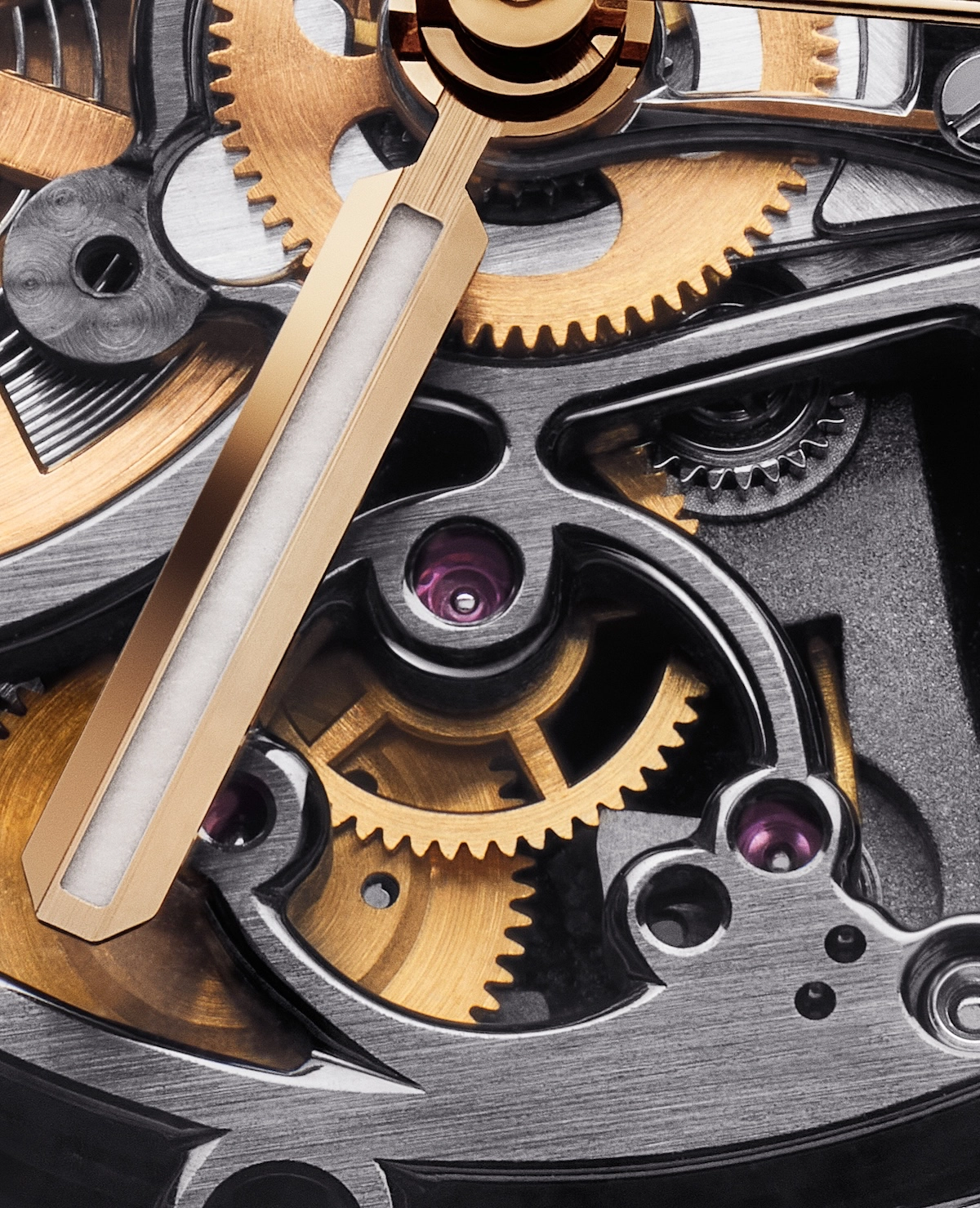 Close-up of watch movement showing gold gears, polished metal parts, and luminous gold watch hands.