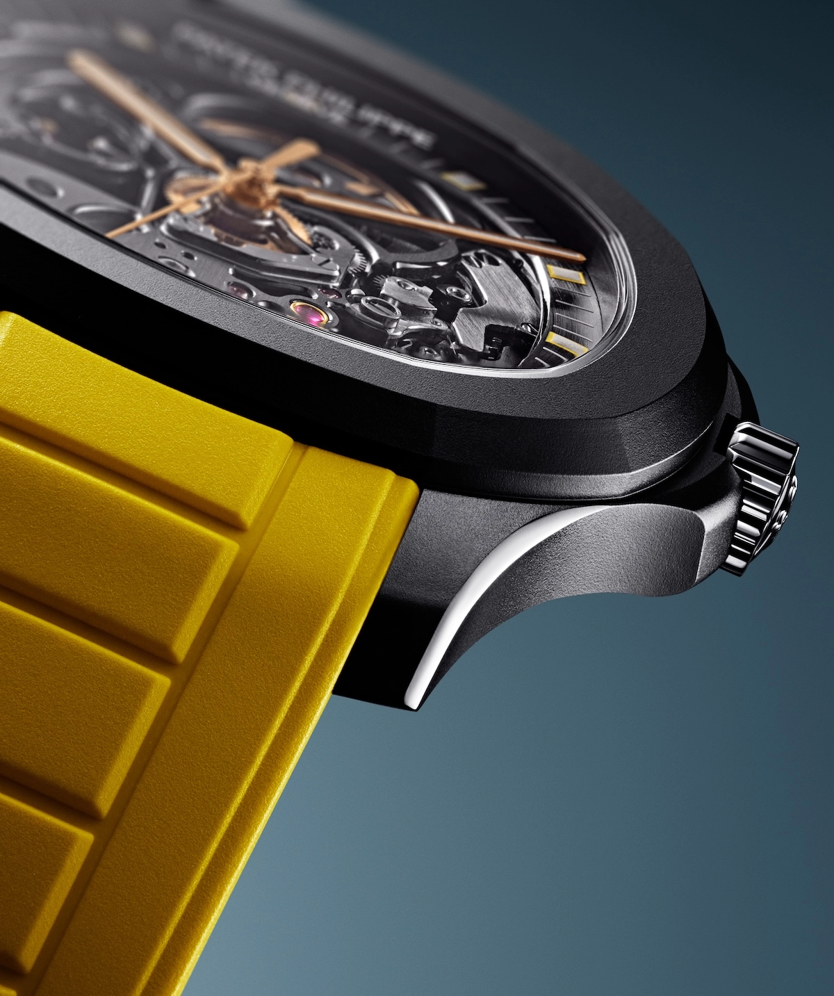 Close-up of a black watch with visible gears and a yellow textured strap against a blue background.