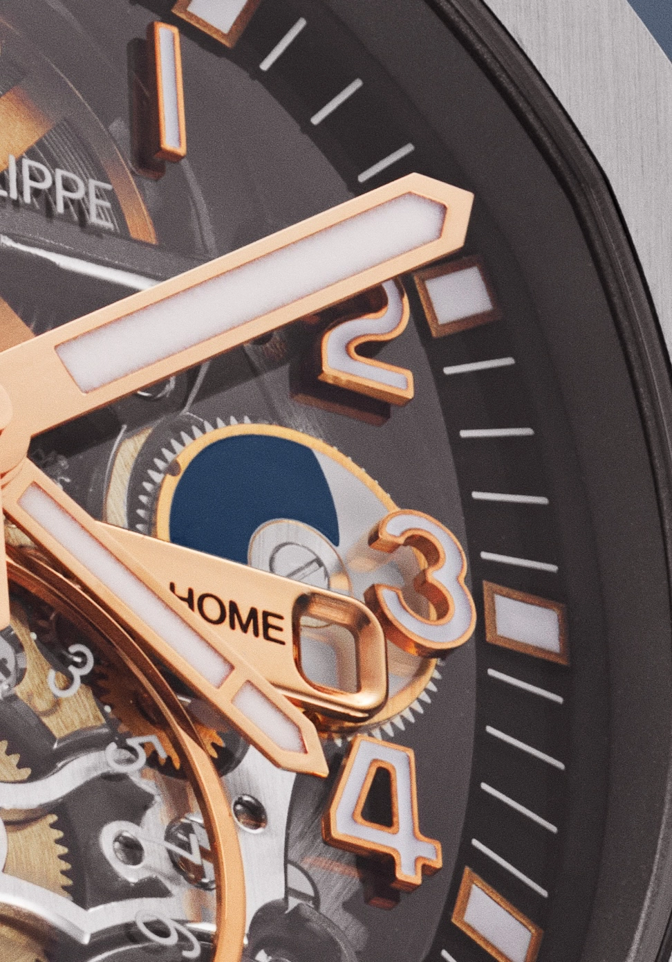 Close-up of a luxury watch dial showing gold hour markers and hands with a moon phase indicator.