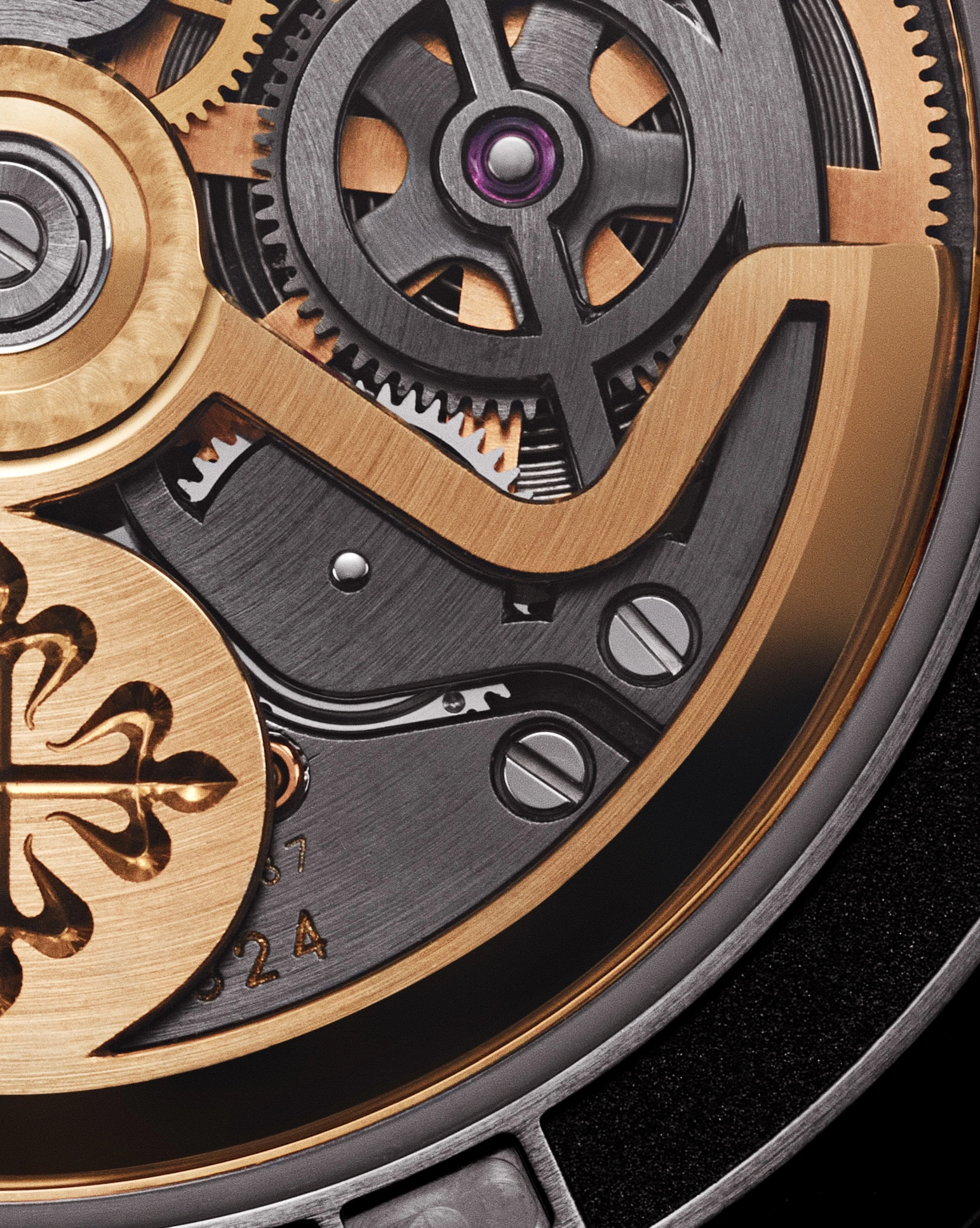 Close-up of a watch's intricate mechanical rotor and gears with gold and black metal components.