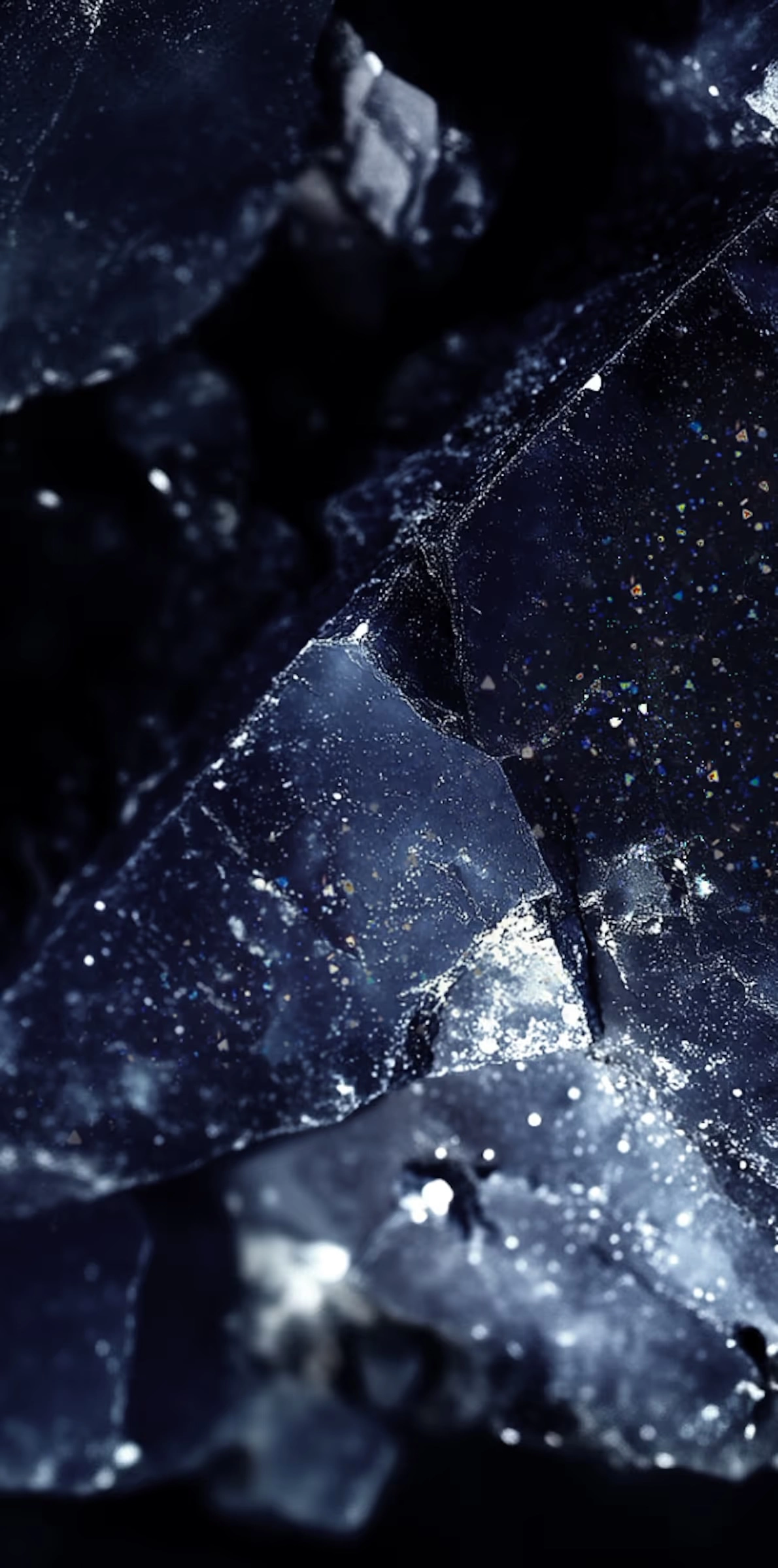 Close-up of dark blue aventurine stone with sparkling inclusions and translucent facets.