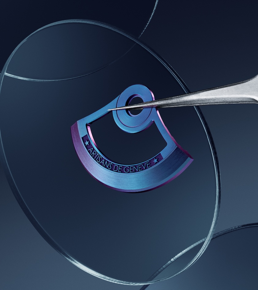 Precision tool holding a metal watch rotor engraved with Artisans de Genève on a glass surface.