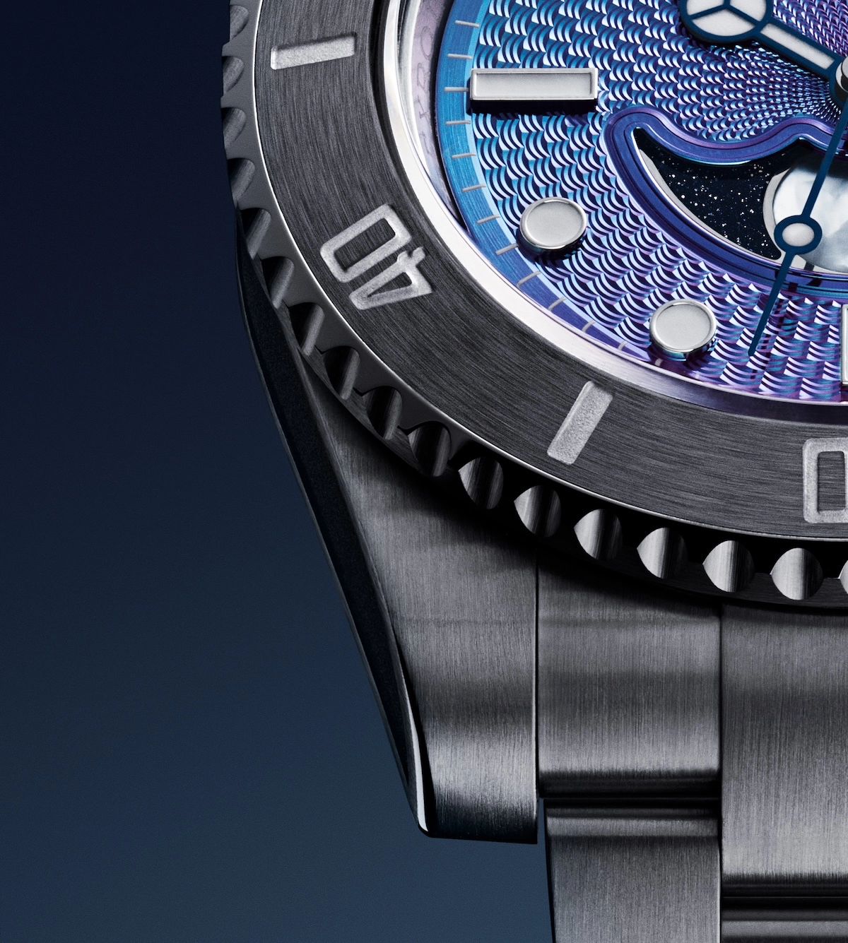 Close-up of a luxury watch with metallic blue textured dial and stainless steel bracelet.