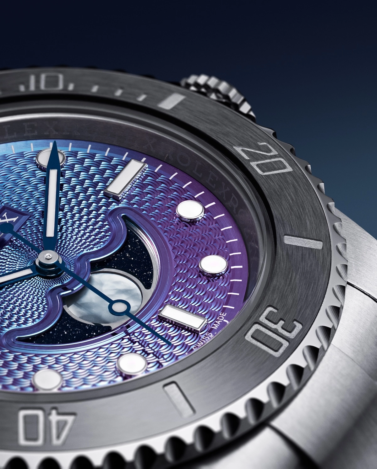 Close-up of a luxury watch with a blue and purple textured dial and a moonphase complication.