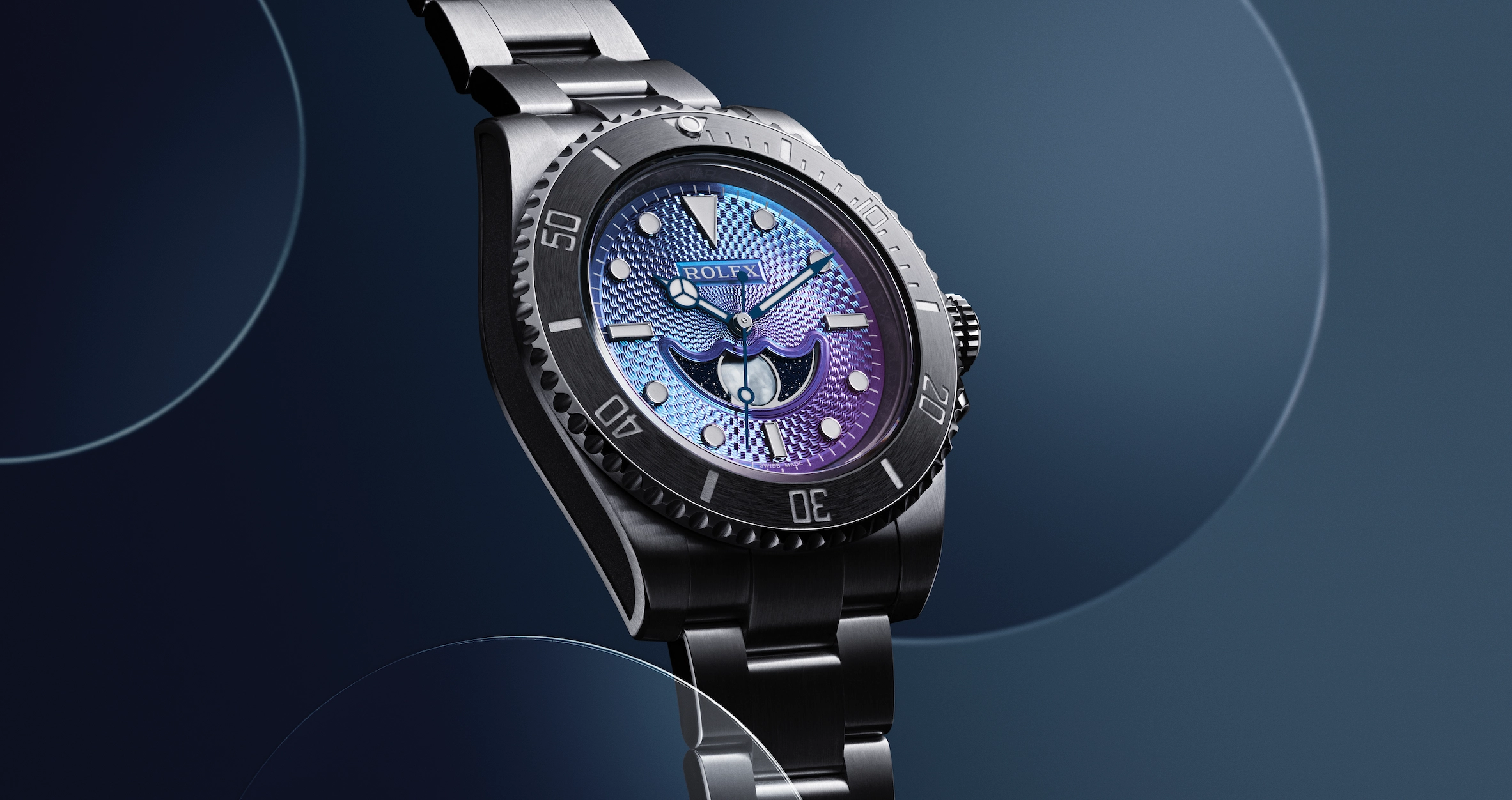 Close-up of silver wristwatch with textured blue and purple dial and rotating bezel on dark background.