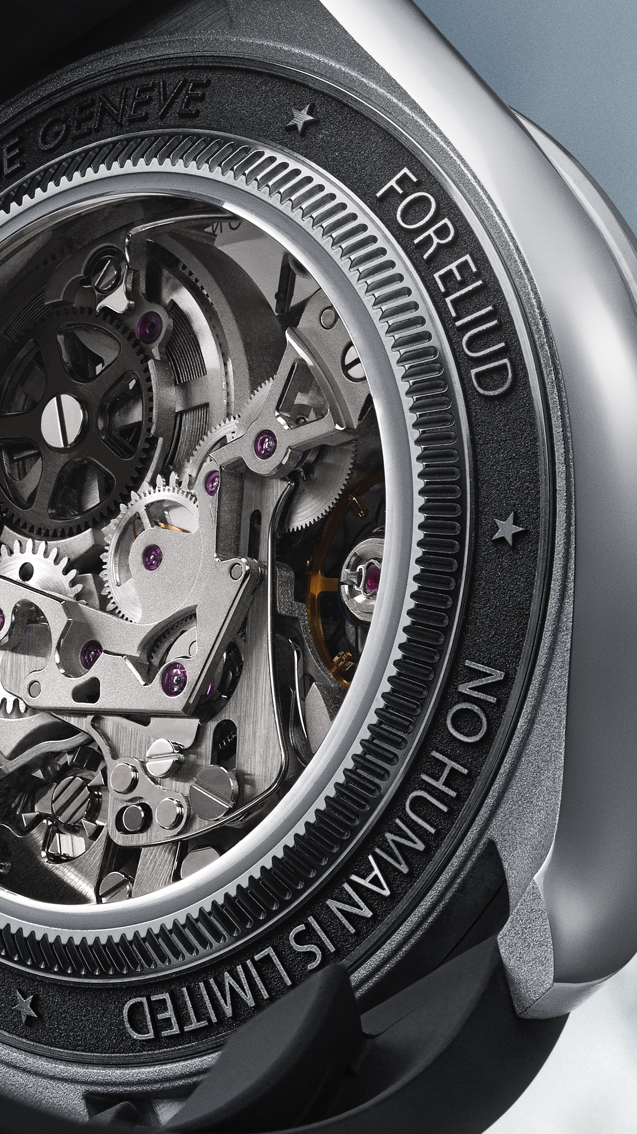 Close-up of a mechanical watch's inner gears and components visible through a transparent case back, with engraved text around the edge reading 'FORELIUD' and 'NO HUMAN IS LIMITED' along with 'ARTISANS DE GENEVE'.