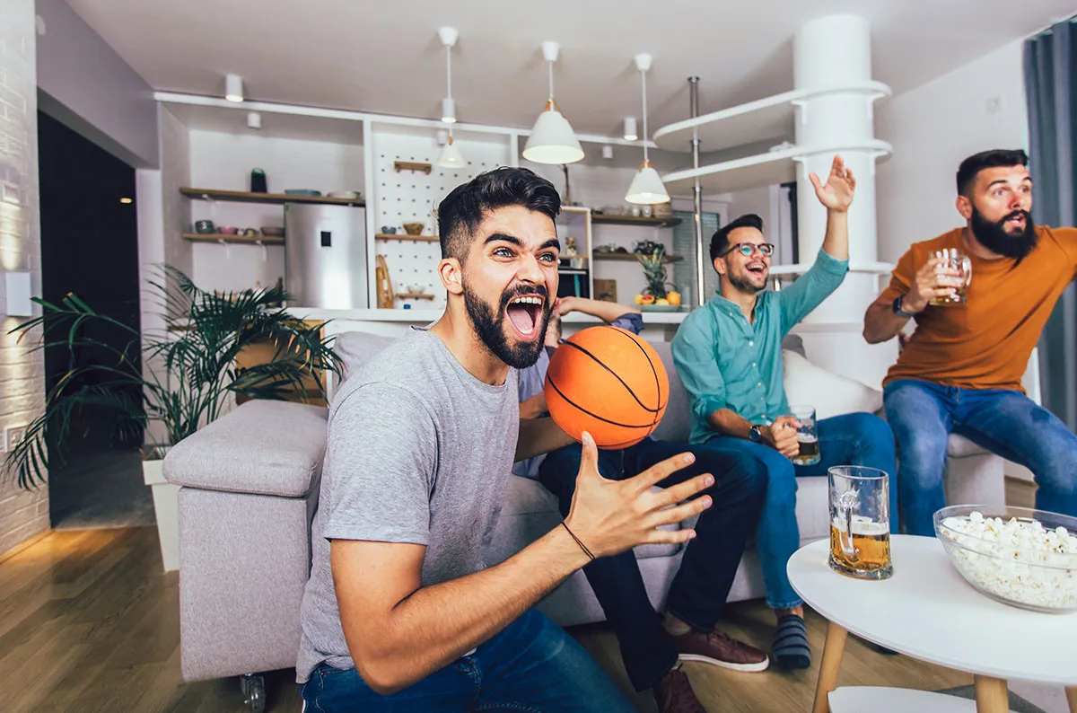 A group of young men playing a game of basketball.