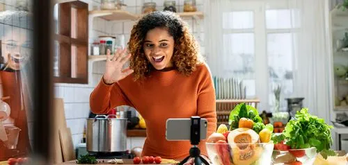 A woman in a kitchen making a funny face.