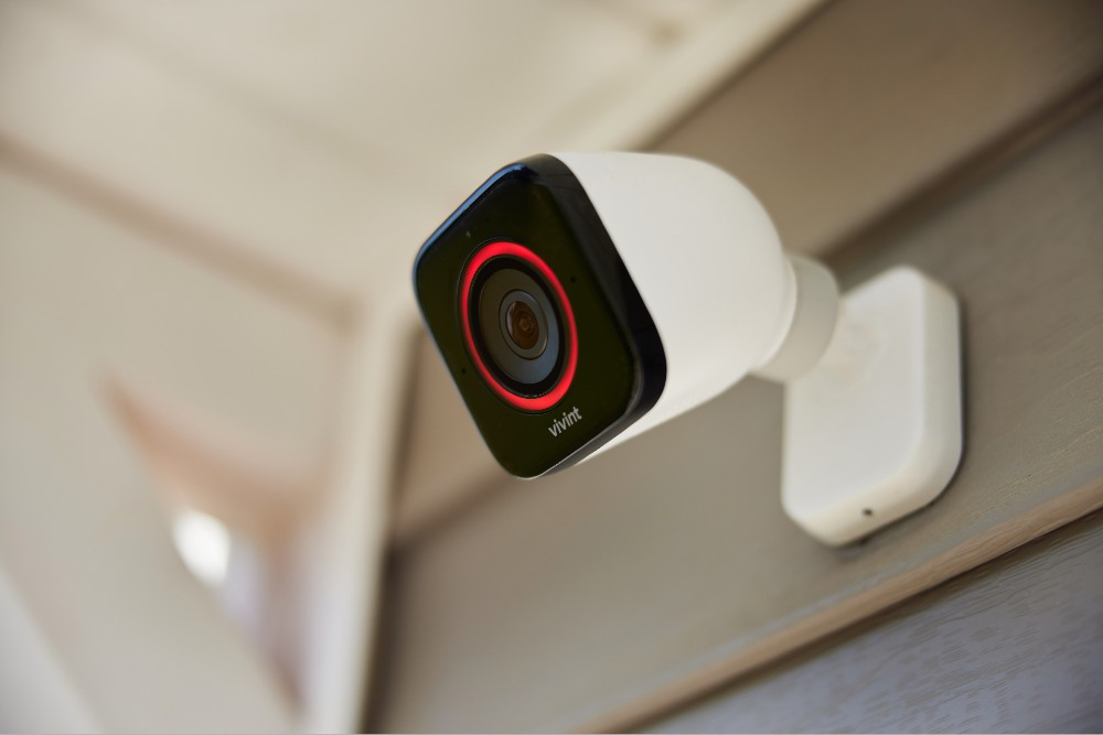 A security camera mounted on the side of a wall.