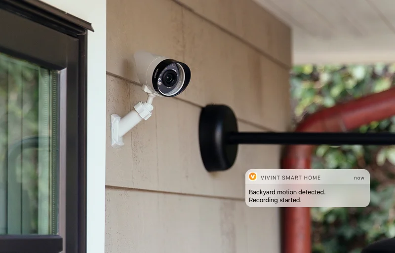 A camera mounted to the side of a building.