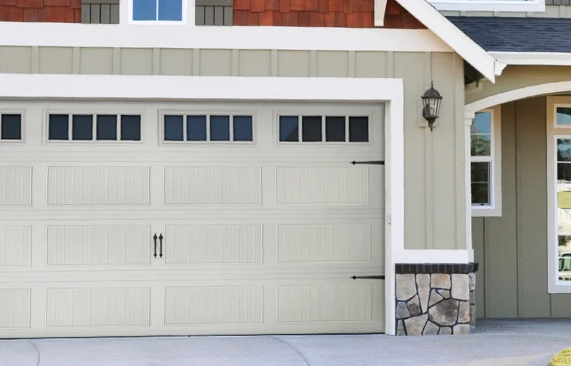 A house with a garage door and windows.