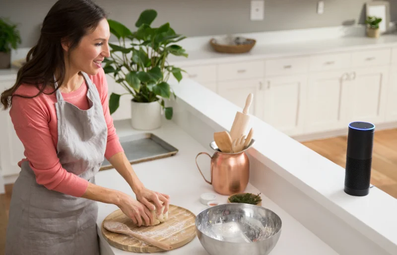 A woman standing in a kitchen preparing food.