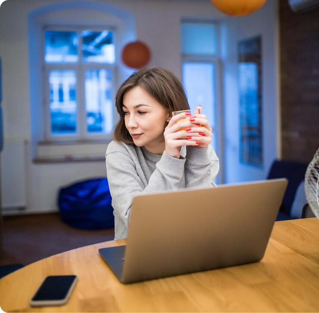 A woman sitting in front of a laptop computer.