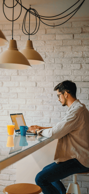 Young guy on laptop researching email marketing strategies