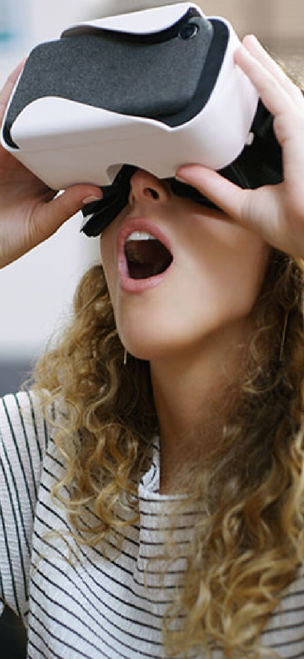 Young girl open-mouthed in amazement of a virtual-reality game