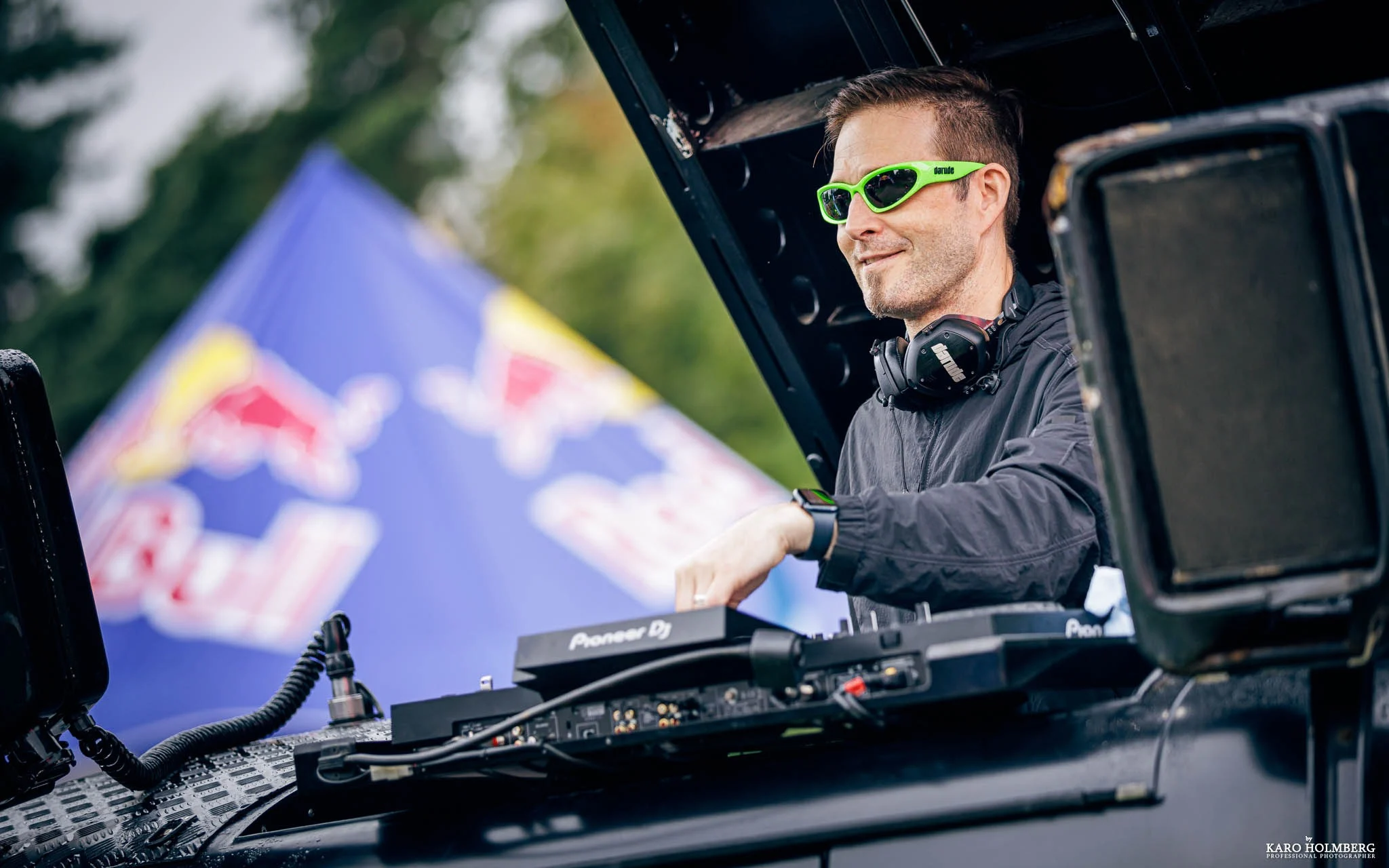 Red running shoes and blue y2k glasses, sitting on top of steps.