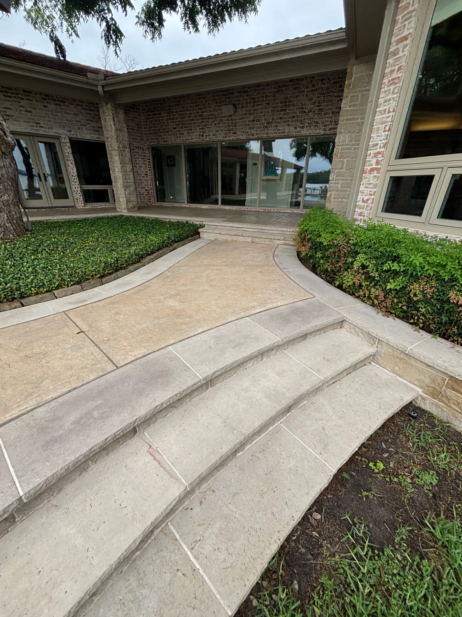 Clean concrete walkway and front steps after pressure washing