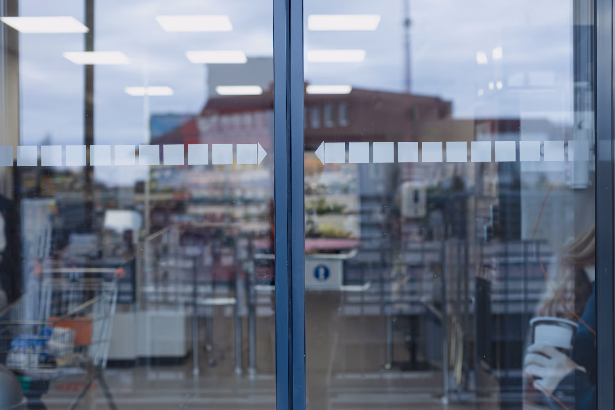 Front sliding glass doors of a grocery store.