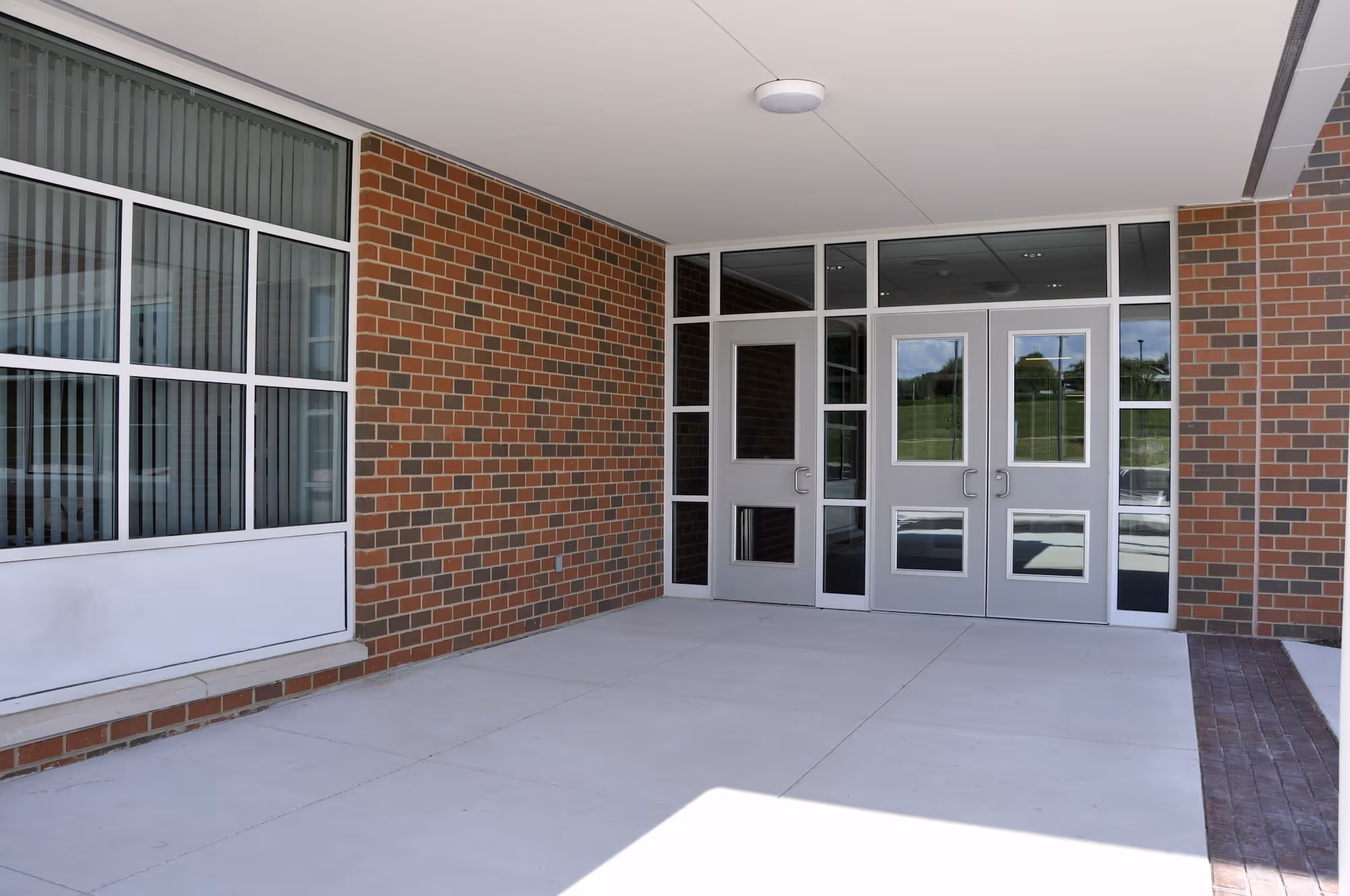 The entryway to a school with secured steel doors.