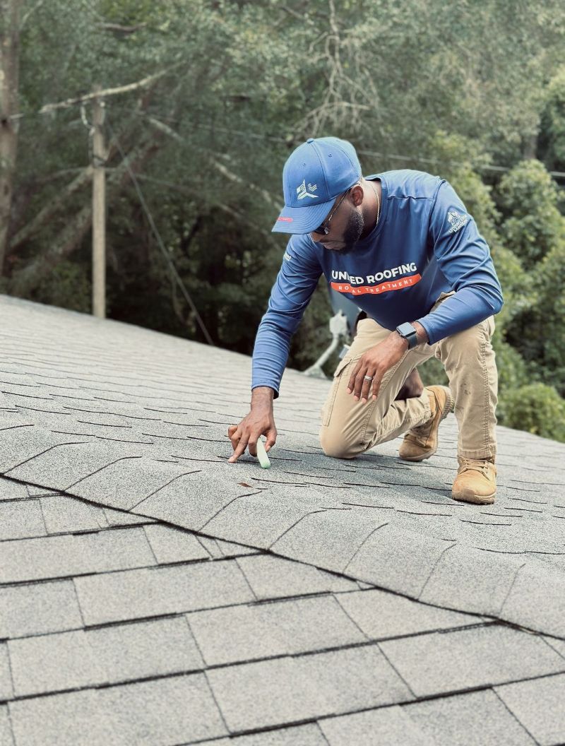 United roofing worker inspecting a roof