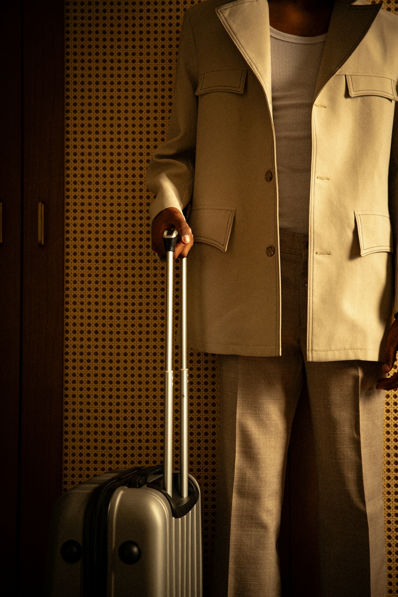 Person holding suitcase