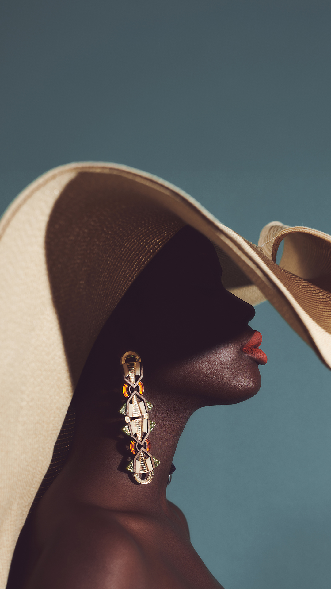 woman in hat with earrings