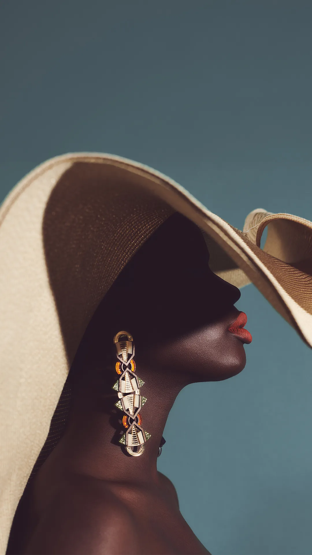 woman in hat with earrings