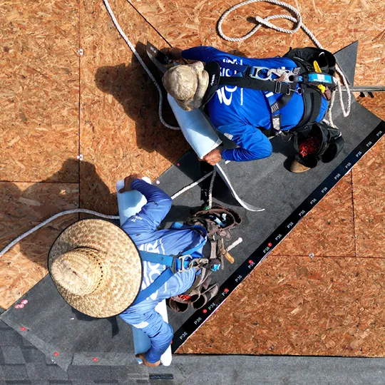 Roofers installing underlayment during roof replacement in Oviedo Florida