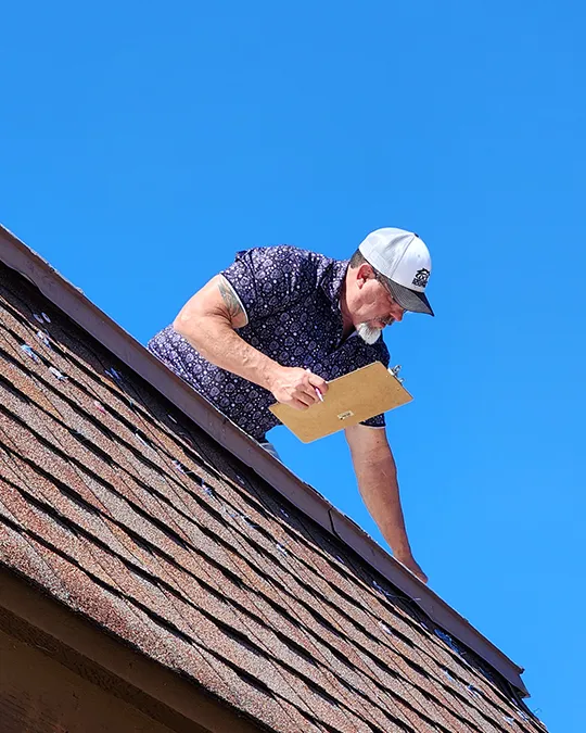 OCR Roofing owner performing a roof maintenance inspection on a roof in Central Florida