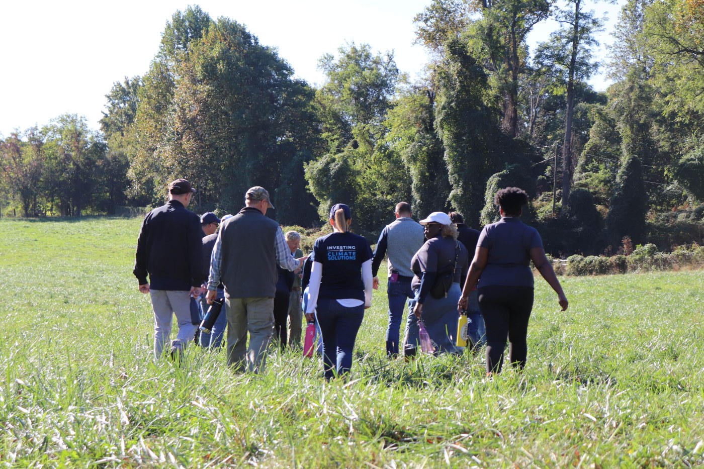 Members of HASI's team volunteering in a grassy field.