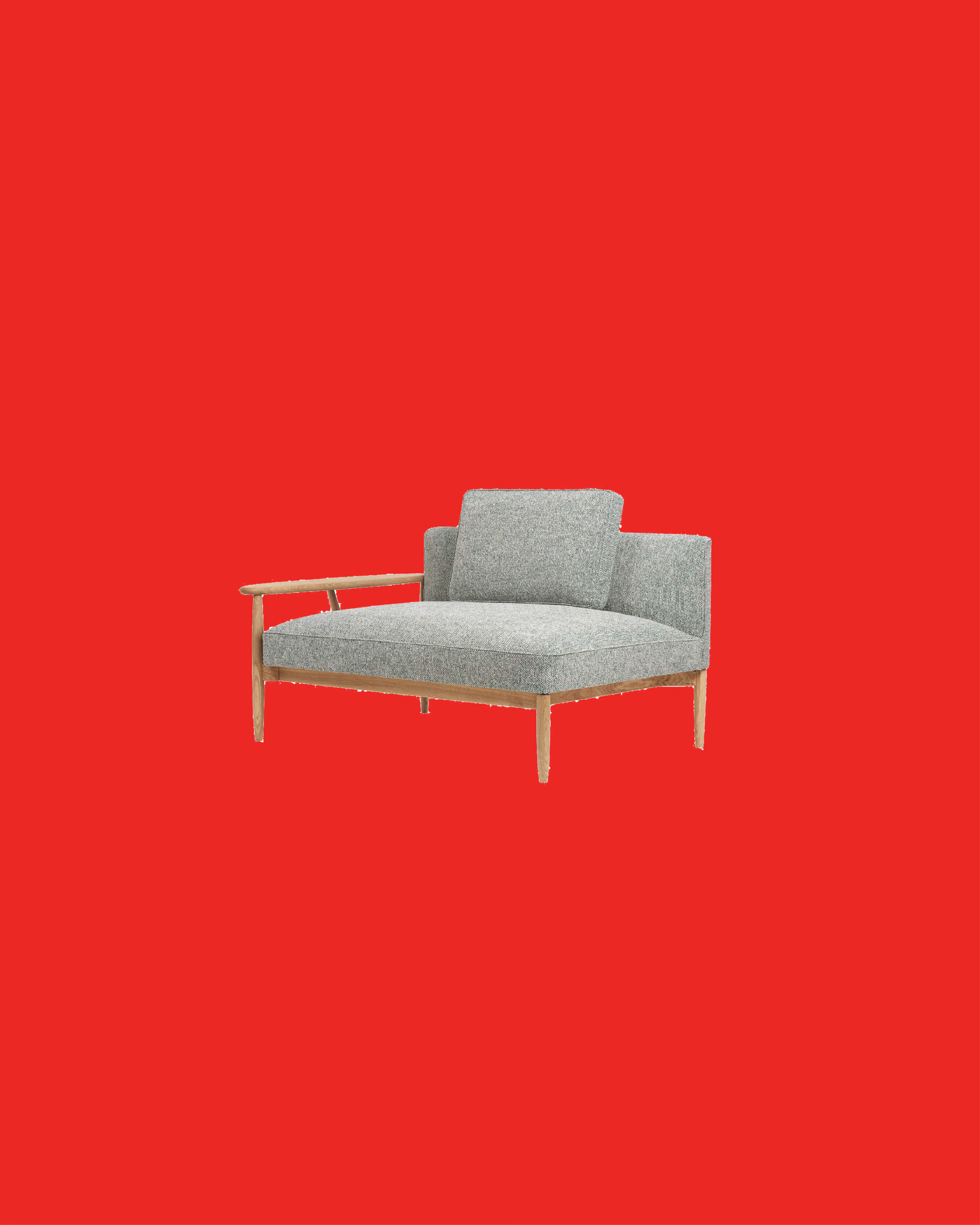 Modern gray fabric armchair with wooden legs and one wooden armrest, set against a solid red background.