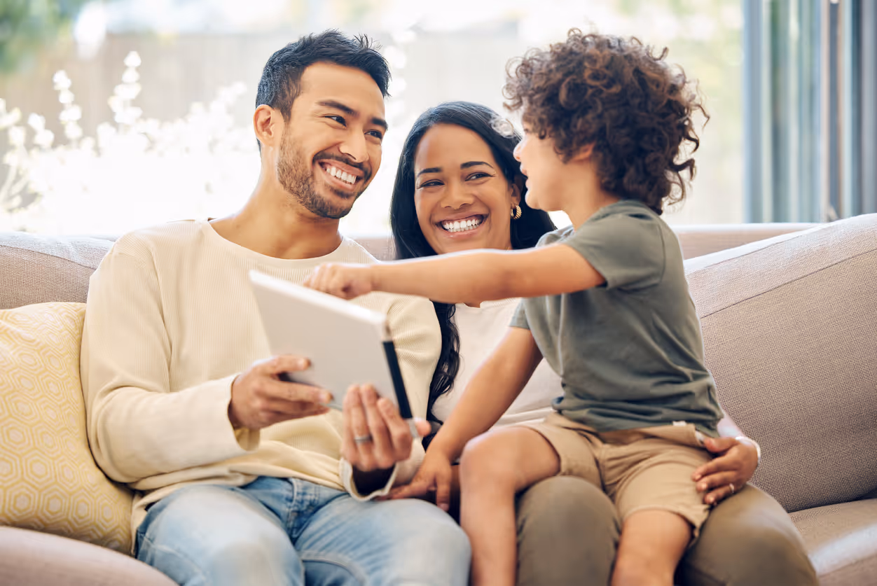 Parents working with their child during an AAC assessment 